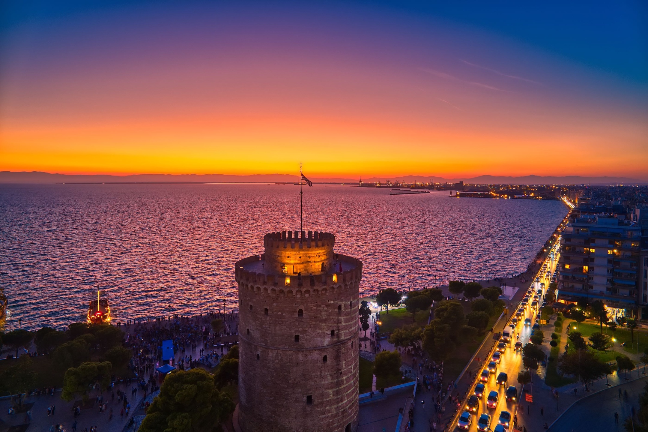 The sun setting over the White Tower and Thermaic Gulf commences the vibrant Thessaloniki nightlife scene.