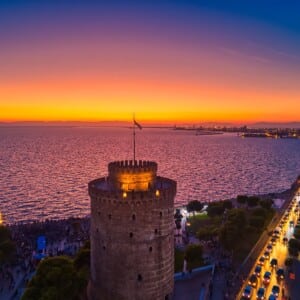 The sun setting over the White Tower and Thermaic Gulf commences the vibrant Thessaloniki nightlife scene.