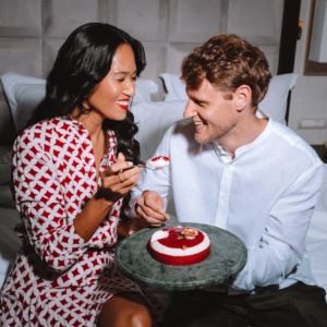 Elegant couple sharing a Valentine’s Day dessert in bed at Electra Hotels in Athens the perfect setting for romantic getaways for couples.