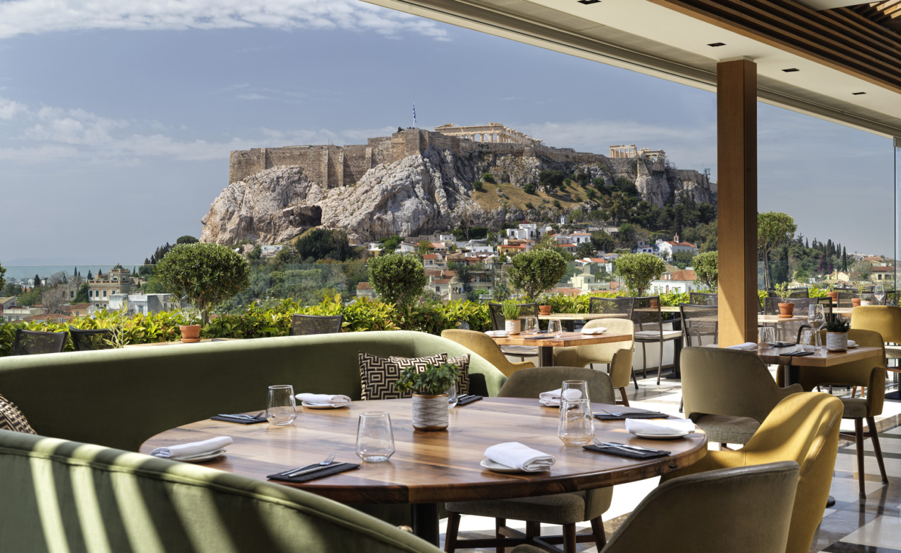 The setting for enjoying gourmet Athens cuisine with Acropolis views at Electra Palace Athens hotel’s rooftop.
